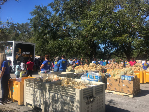 Volunteers pack food at the Hometown Huddle Service Event with the Jaguars Foundation.
